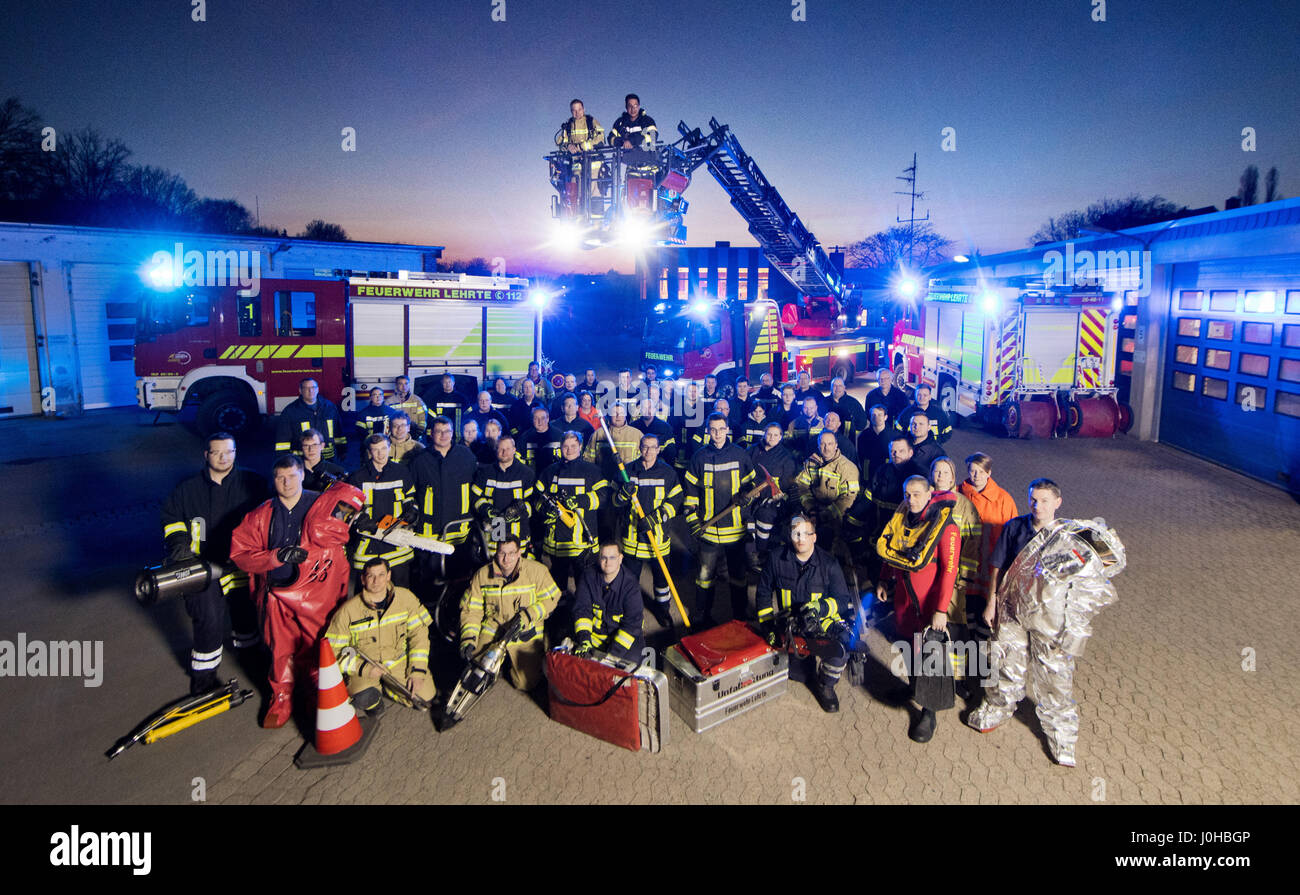 Lehrte, Germany. 16th Mar, 2017. Members of the voluntary fire brigade pose for a group photo in Lehrte, Germany, 16 March 2017. The volunteers' psychologically and physically draining work was honoured with the Fire Brigade Team of the Year award in 2016. Photo: Julian Stratenschulte/dpa/Alamy Live News Stock Photo
