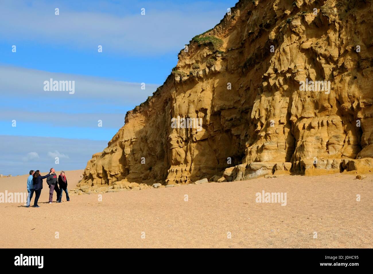 West Bay, Dorset, UK. 14th Apr, 2017. Visitors look at Weat Bays East Cliff, made famous in the TV series Broadchurch during a sunny morning at West Bay on the Dorset coast. Credit: Tom Corban/Alamy Live News Stock Photo