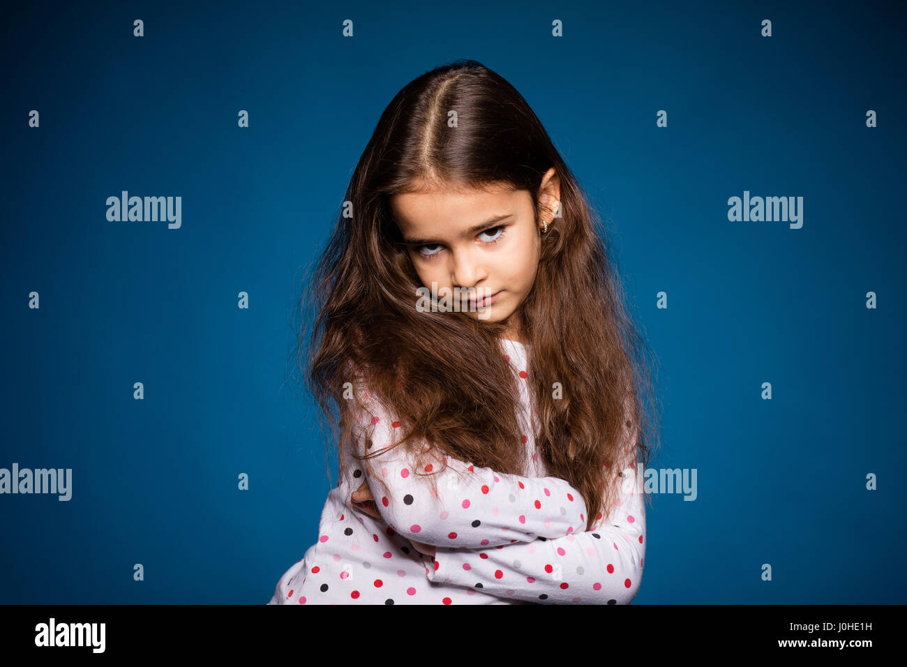 beautiful little girl with curls, being sad and angry Stock Photo