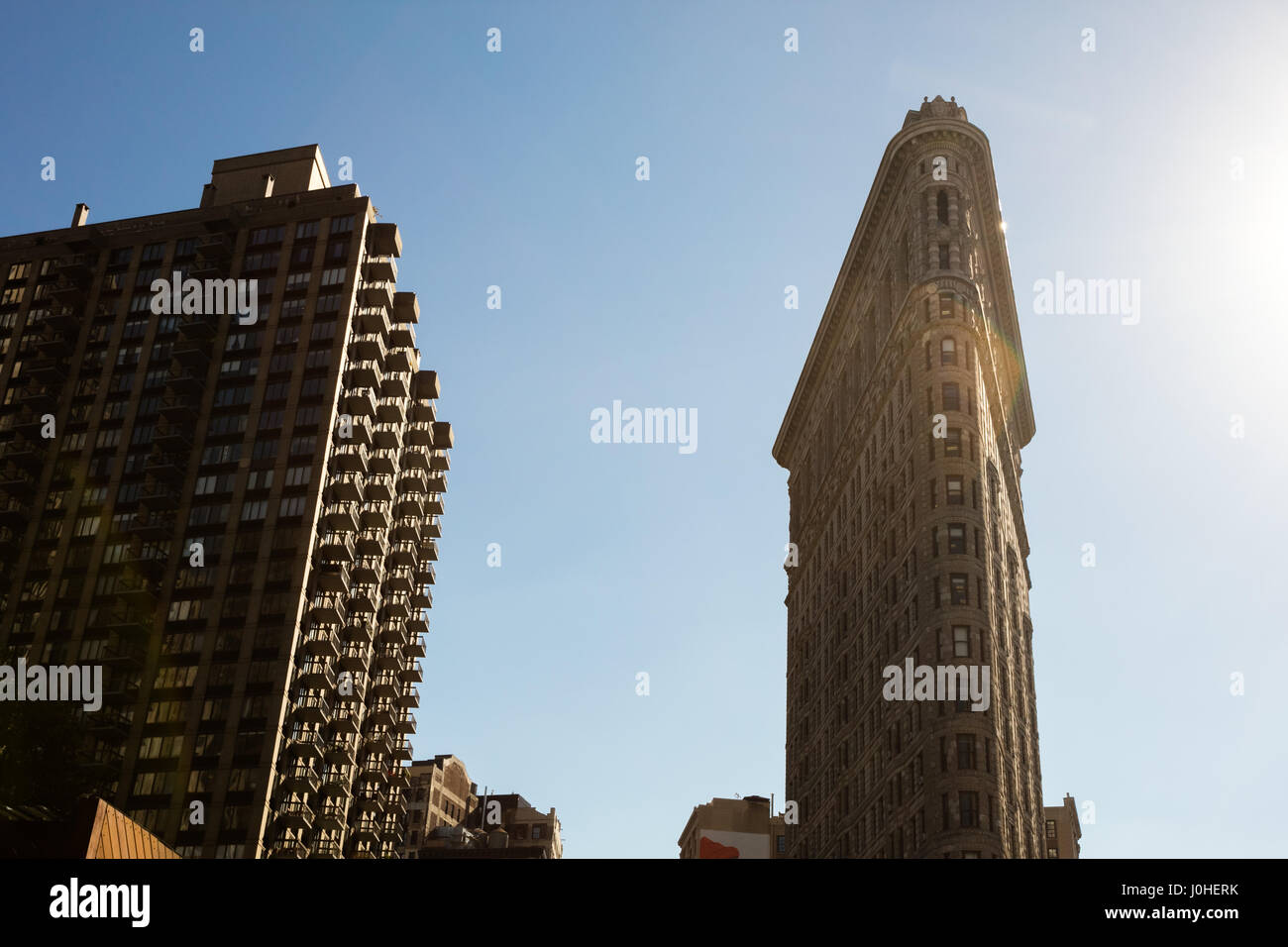 Low Angle Architectural Exterior View of Upper Floors of Historic Flatiron Building in Warm Afternoon Sunlight, Manhattan, New York City, New York, US Stock Photo