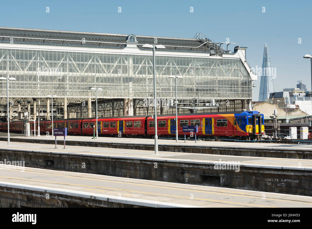 South West Trains leaving from the old shorter platforms at London Waterloo station on a bright, sunny day Stock Photo