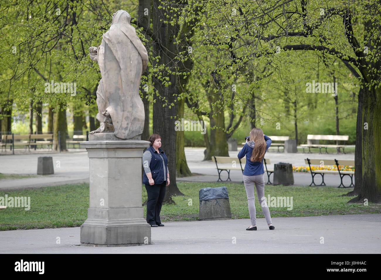 A young woman is seen taking a portrait in the Ogrod Saski park in Warsaw on 11 April, 2017. Stock Photo