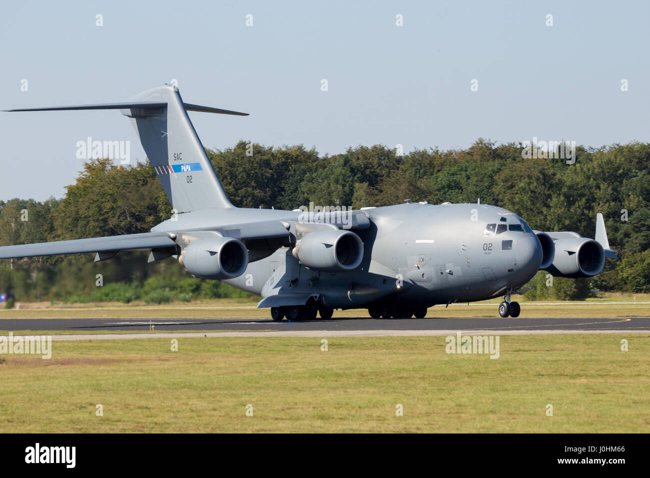 GILZE RIJEN, THE NETHERLANDS - Military Boeing C-17 Globemaster III cargo plane touch-and-go.The plane belongs to SAC and is used by a consortium of 1 Stock Photo
