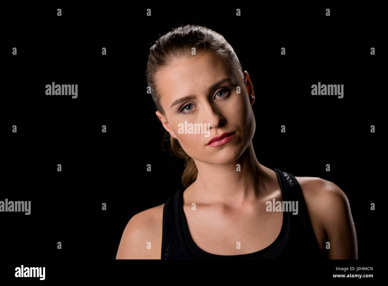 Portrait of attractive serious young woman looking at camera Stock ...