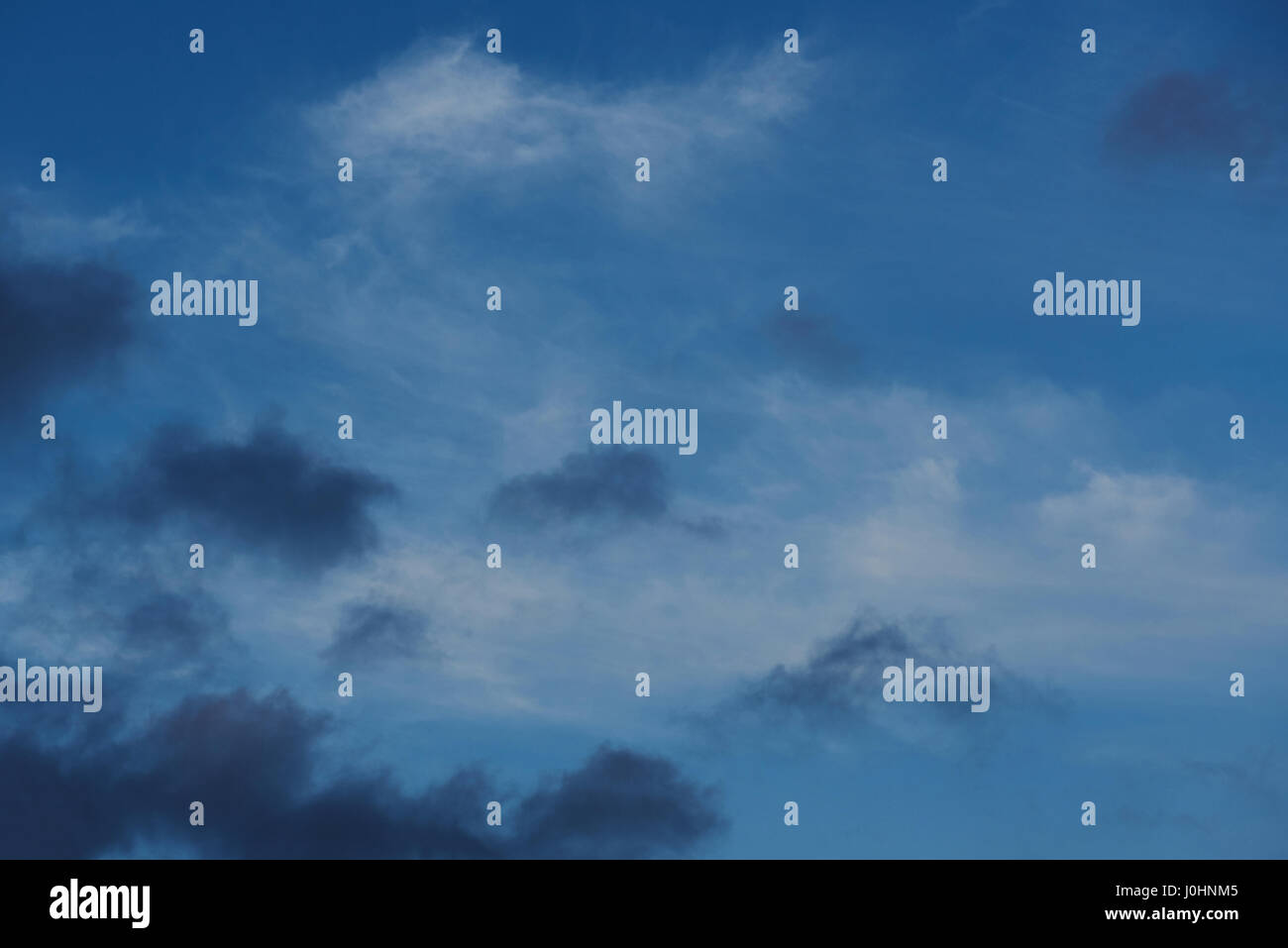 Black and white clouds on blue sky background Stock Photo - Alamy