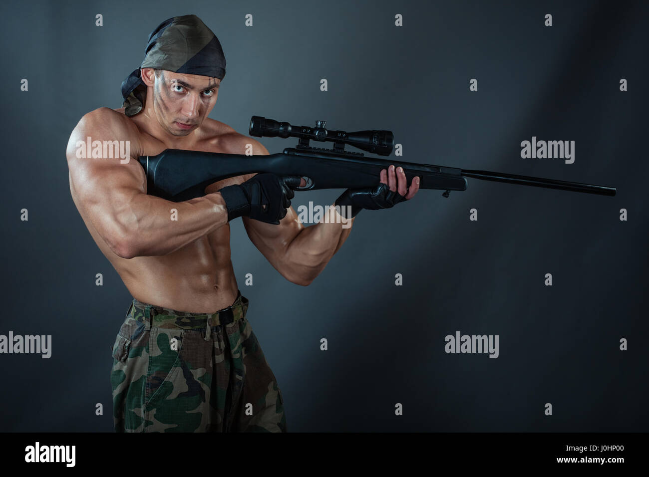 A man holding a rifle. Rifle with a telescopic sight. He was a sniper. Stock Photo