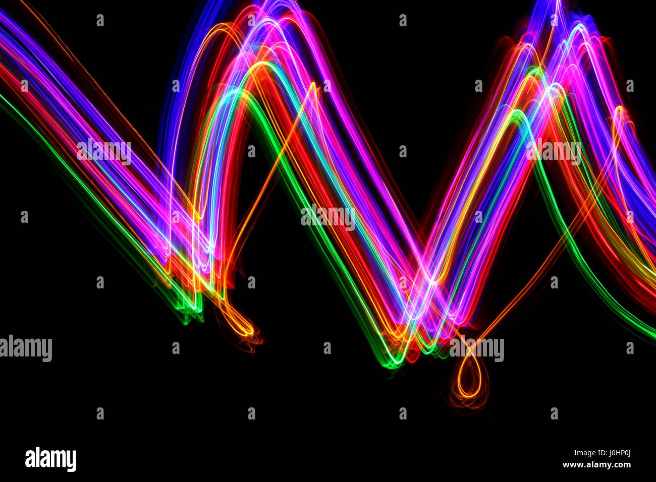 Light painting photography on a black background. Abstract neon swirls ...