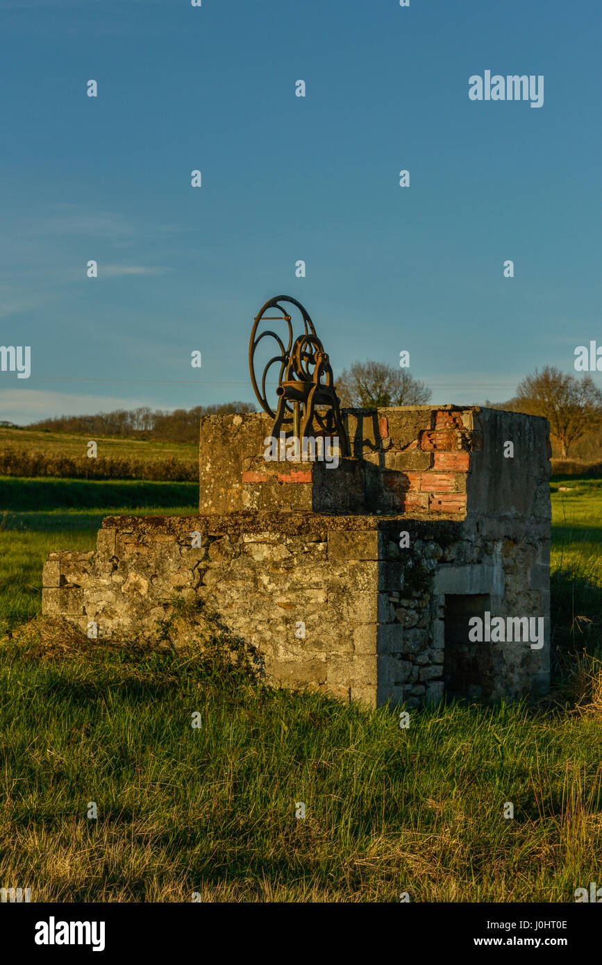 Early 19th century farmers well pump in field, France. Stock Photo