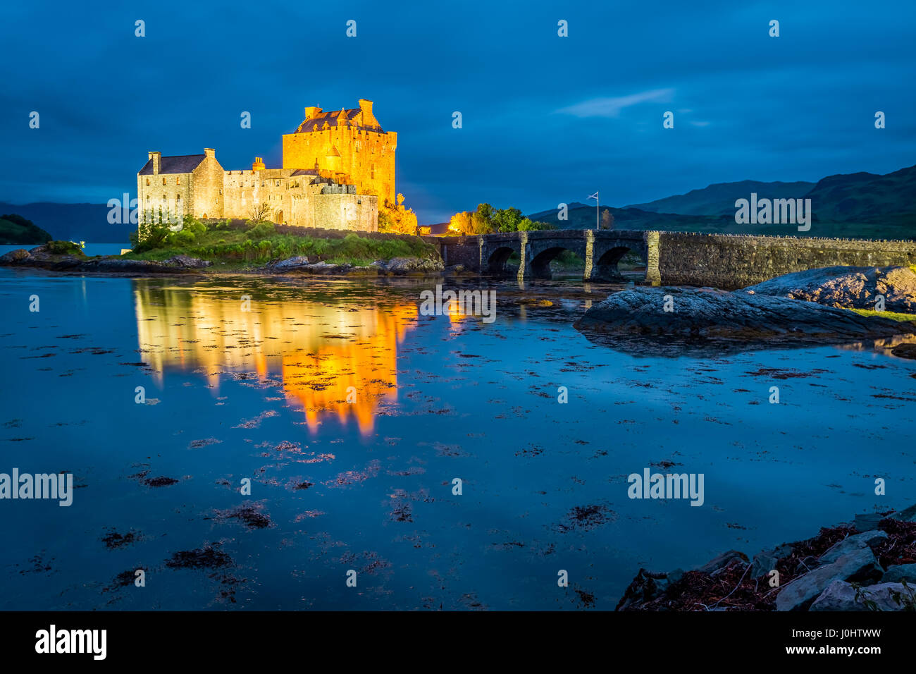 Stunning sunset over lake at Eilean Donan Castle in Scotland Stock Photo