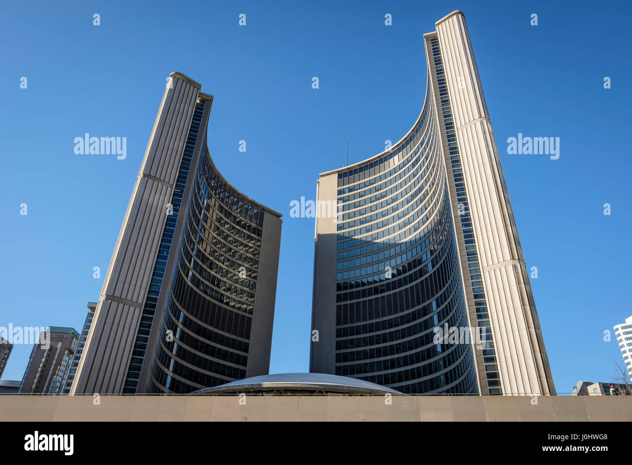 Toronto City Hall, Nathan Phillips Square in winter, facade of the two towers, view from below, downtown Toronto, Ontario, Canada. Stock Photo