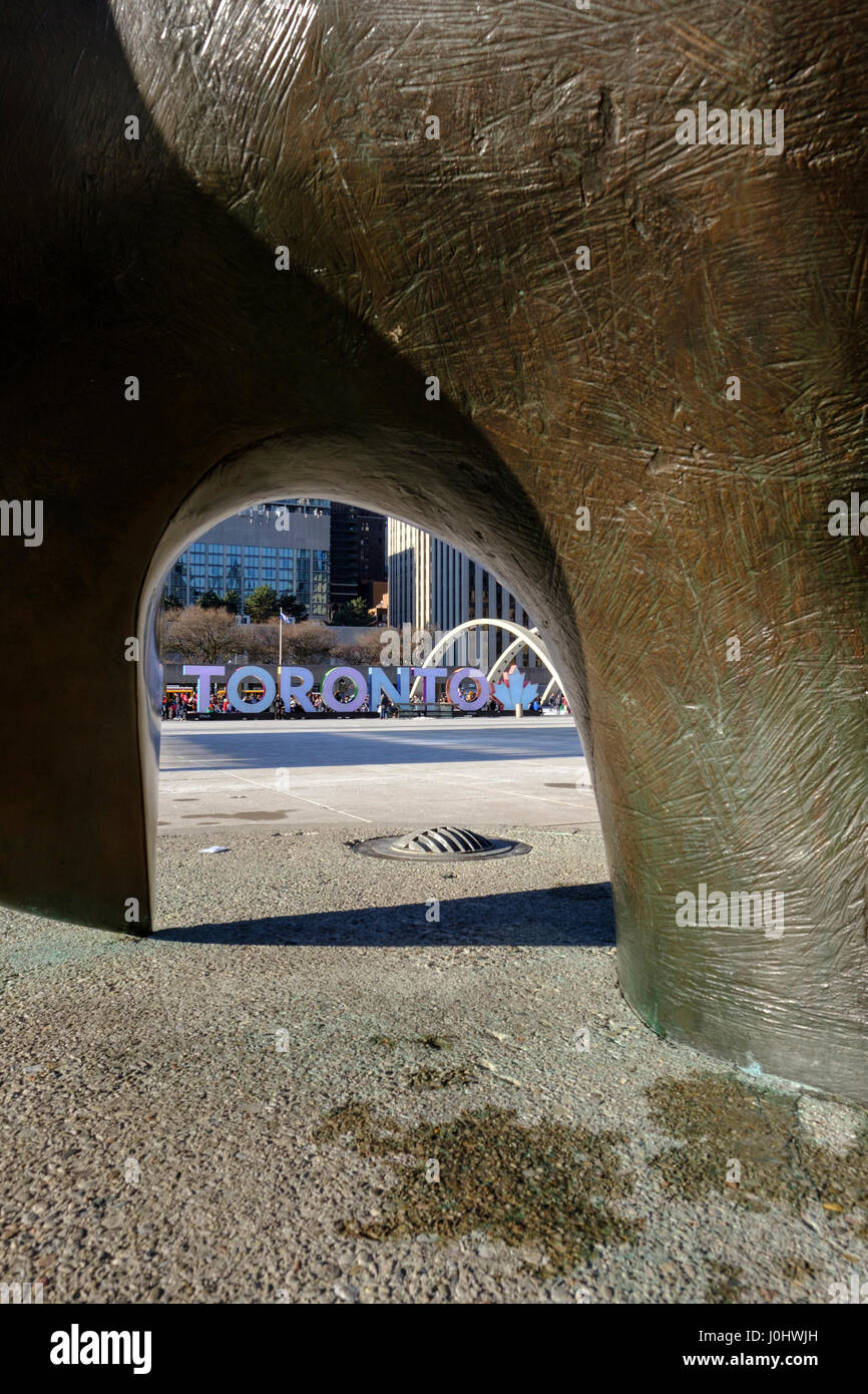 Toronto City Hall, Nathan Phillips Square, horizontally inverted image of Toronto sign viewed from The Archer by Henry Moore, Toronto, Ontario, Canada Stock Photo
