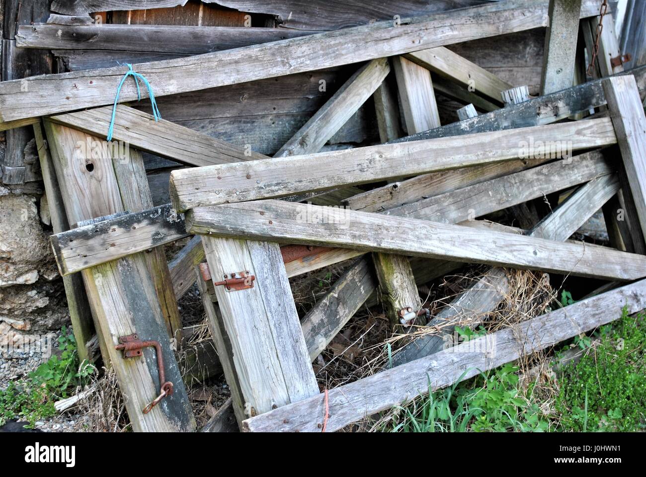 Old gates leaning on a wall. Stock Photo