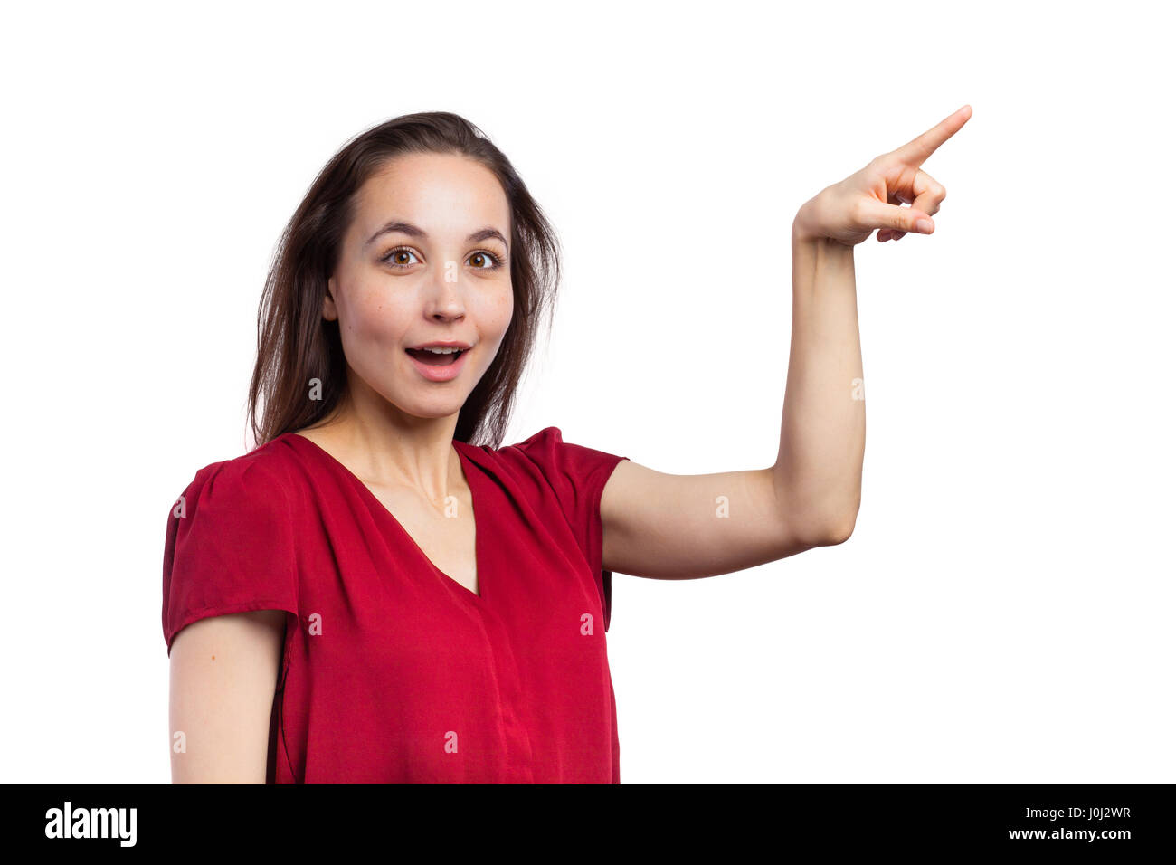 Subtle Pointing Casual brunette pointing at copy space, isolated on white Stock Photo ...
