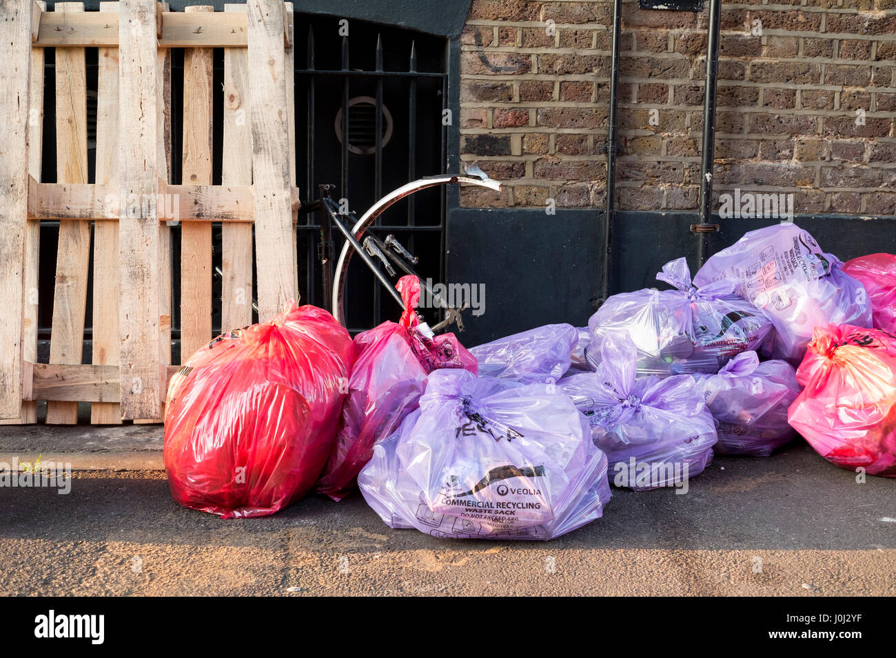 Bags of commercial rubbish and recycling left out for collection Stock Photo