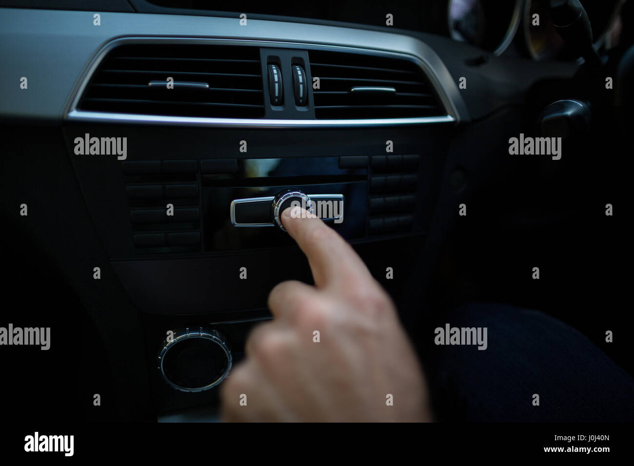 Hand adjusting volume control hi-res stock photography and images - Alamy