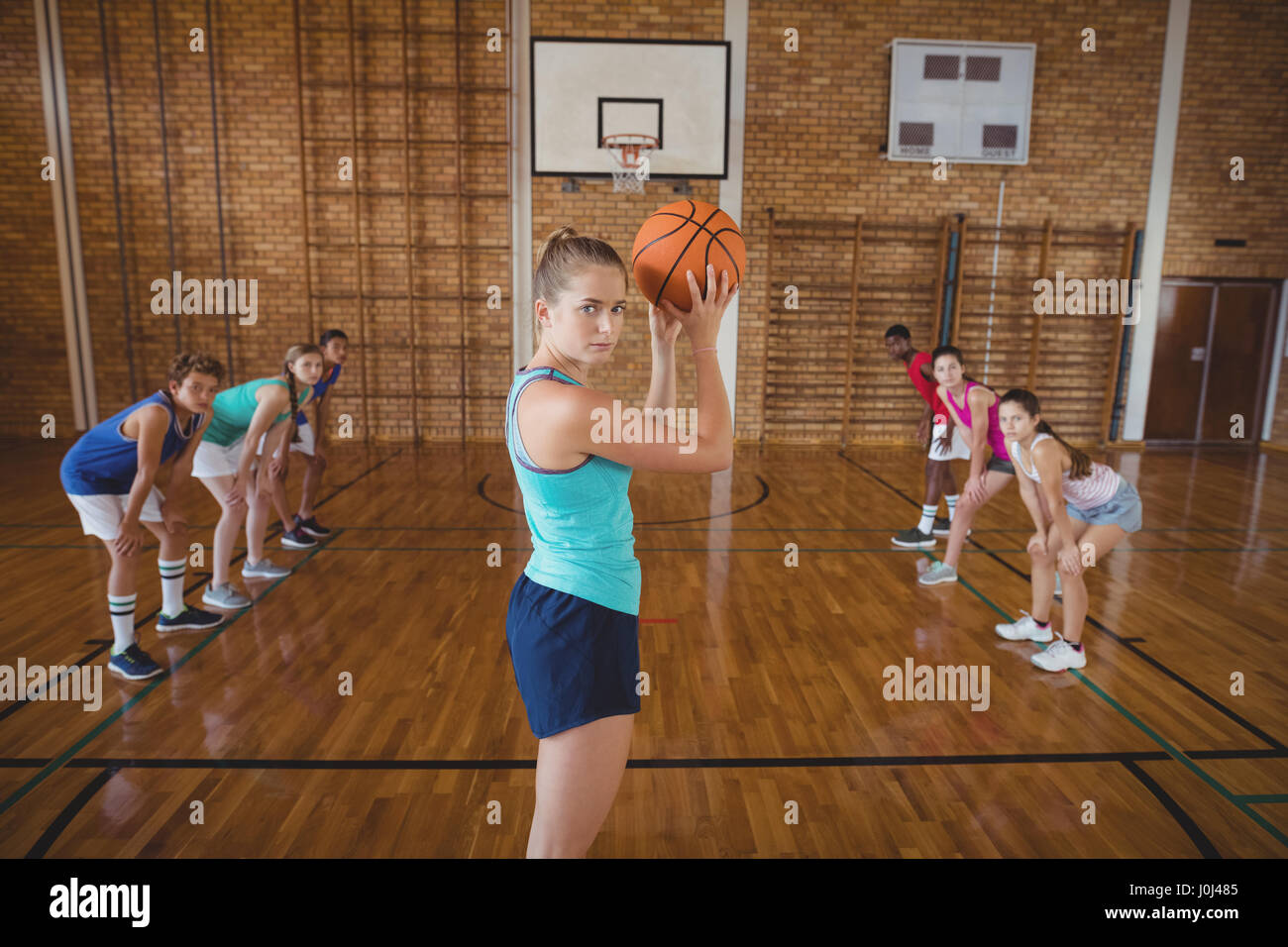 Portrait of high school girl about to take a penalty shot while playing  basketball in the court Stock Photo - Alamy