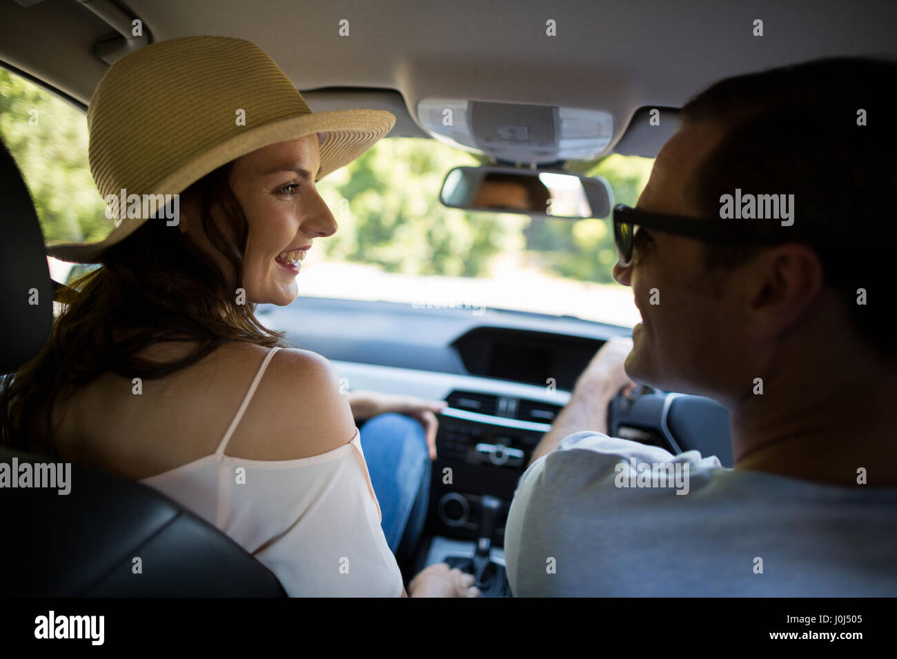 Rear view of young couple driving car Stock Photo