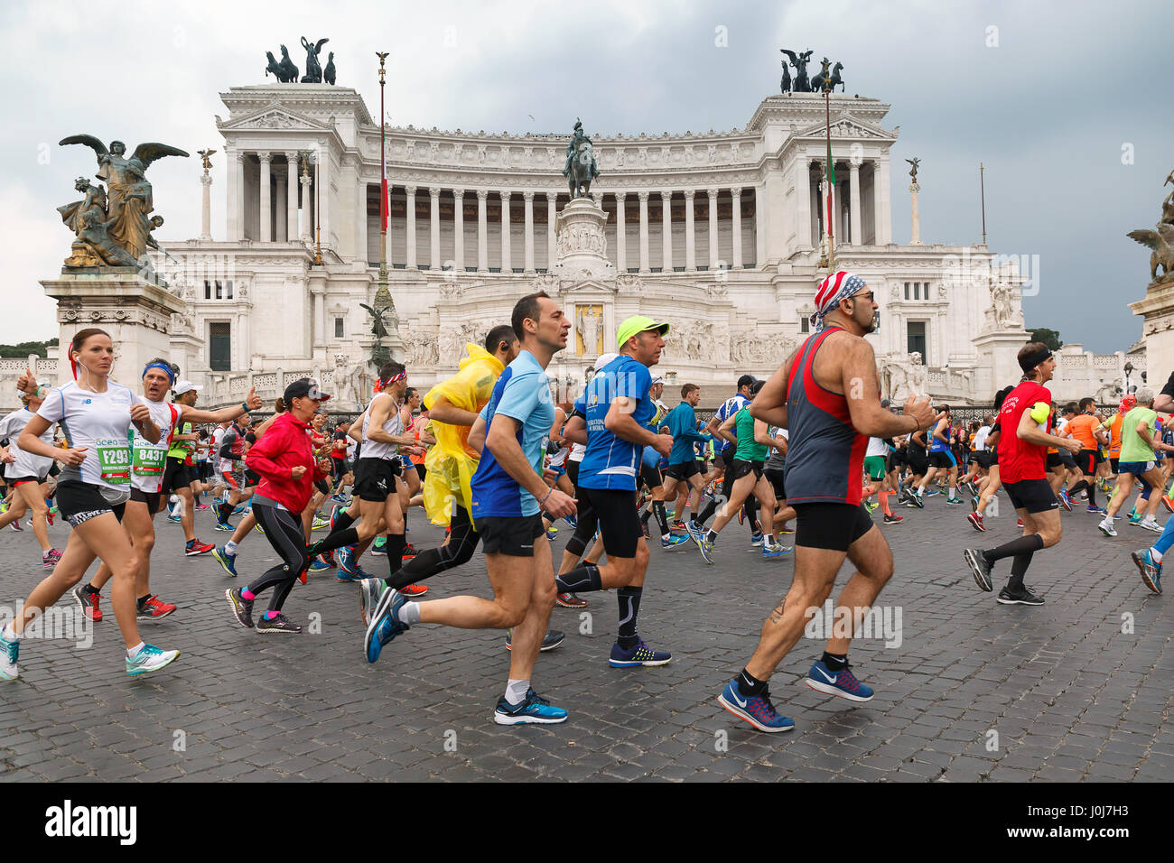 Rome, Italy - April 2, 2017: Athletes participating at the 23rd Rome marathon run through the street circuit passing in front of the altar of the home Stock Photo