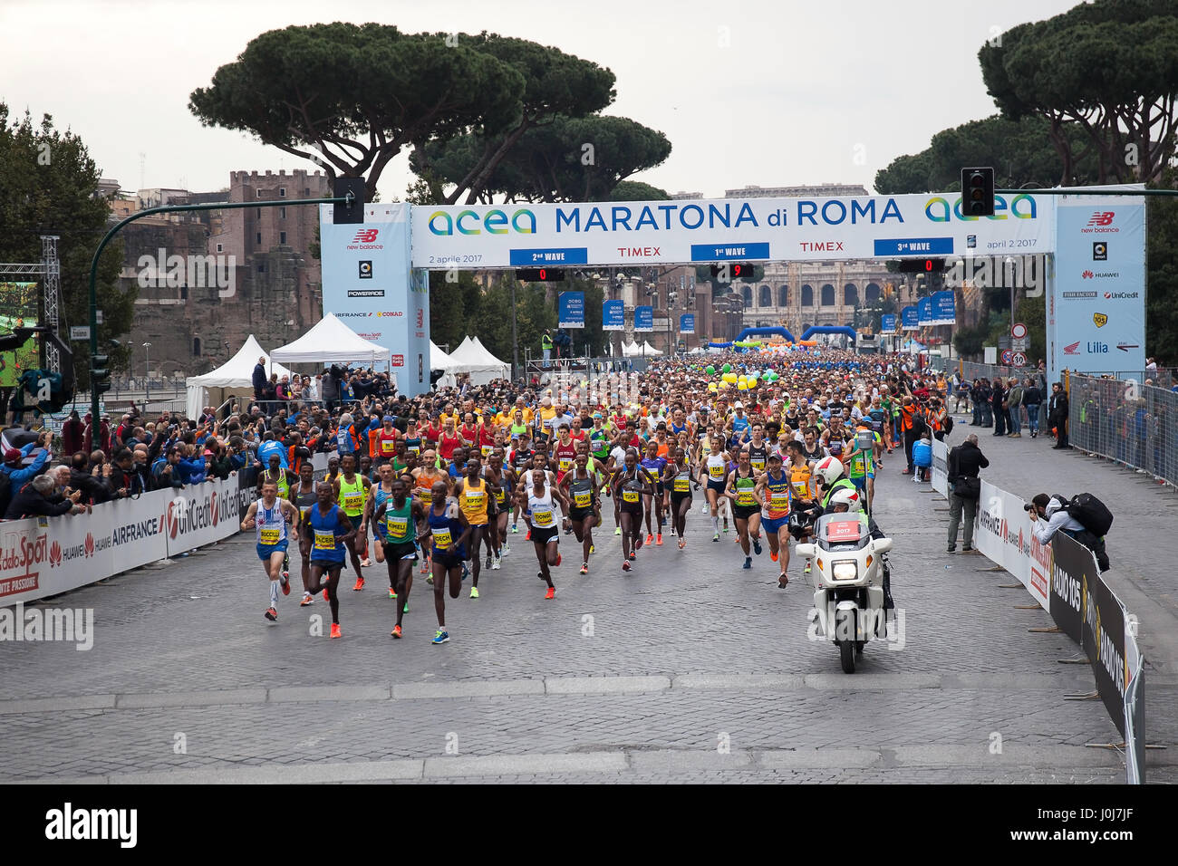 Rome, Italy - April 2, 2017: the departure of the athletes on Via dei Fori Imperiali, the Coliseum on background. Stock Photo