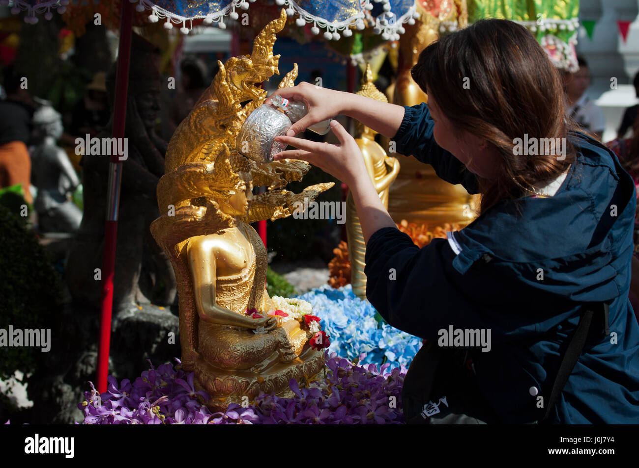 Bangkok, Thailand. 13th Apr, 2017. 13 April, 2017. Chinese tourist pour water on a statue of Buddha as part of celebrations of the Songkran Festival celebrations in Bangkok, Thailand. Credit: Anusak Laowilas/Pacific Press/Alamy Live News Stock Photo