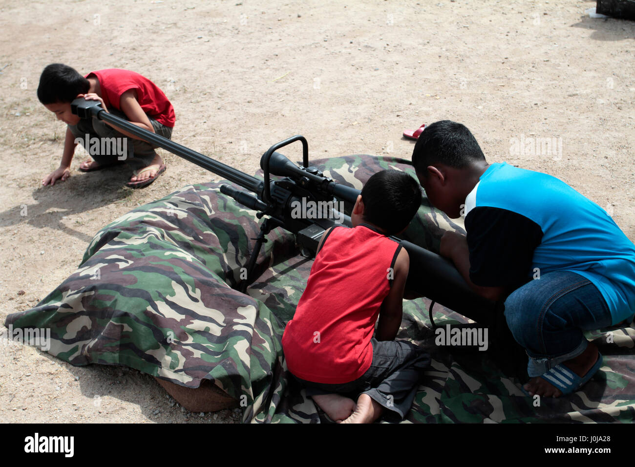 Kids playing with gun Stock Photo Alamy