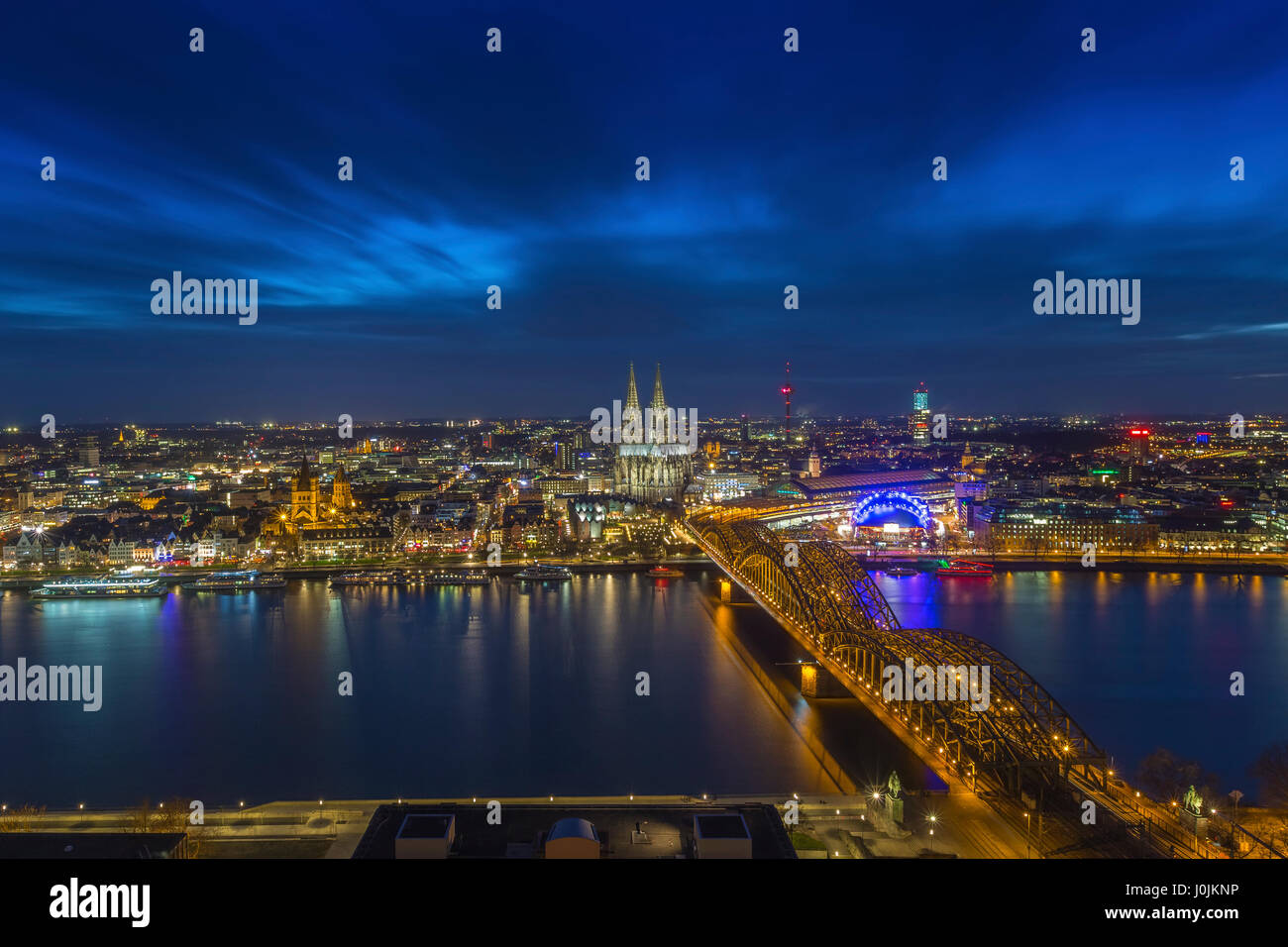 Cologne, Germany - Aerial skyline view of Cologne with the beautiful Cologne Cathedral, Rhine River and Hohenzollern Bridge by night Stock Photo
