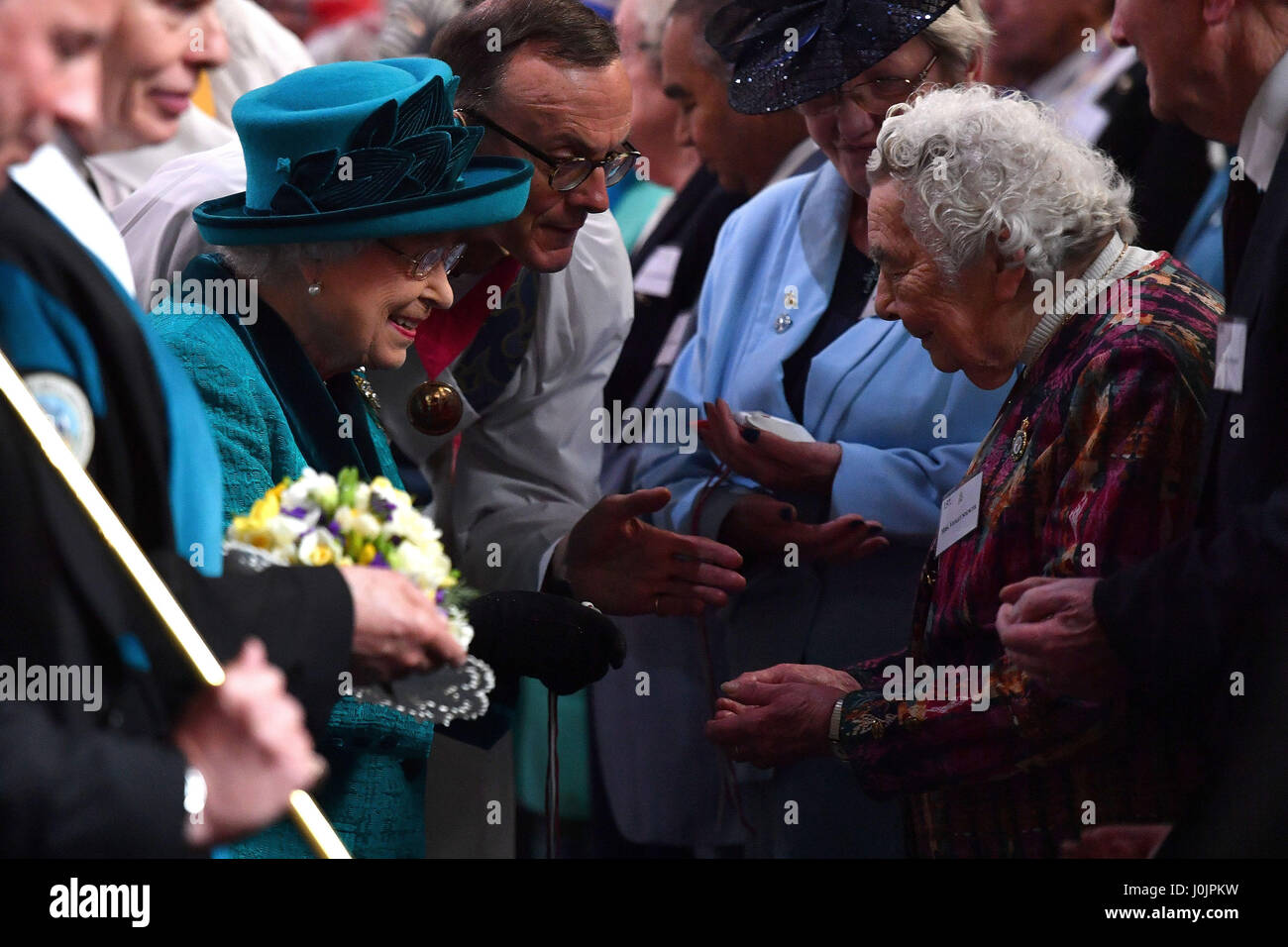 Queen Elizabeth II distributes the traditional Maundy money to 91 men ...