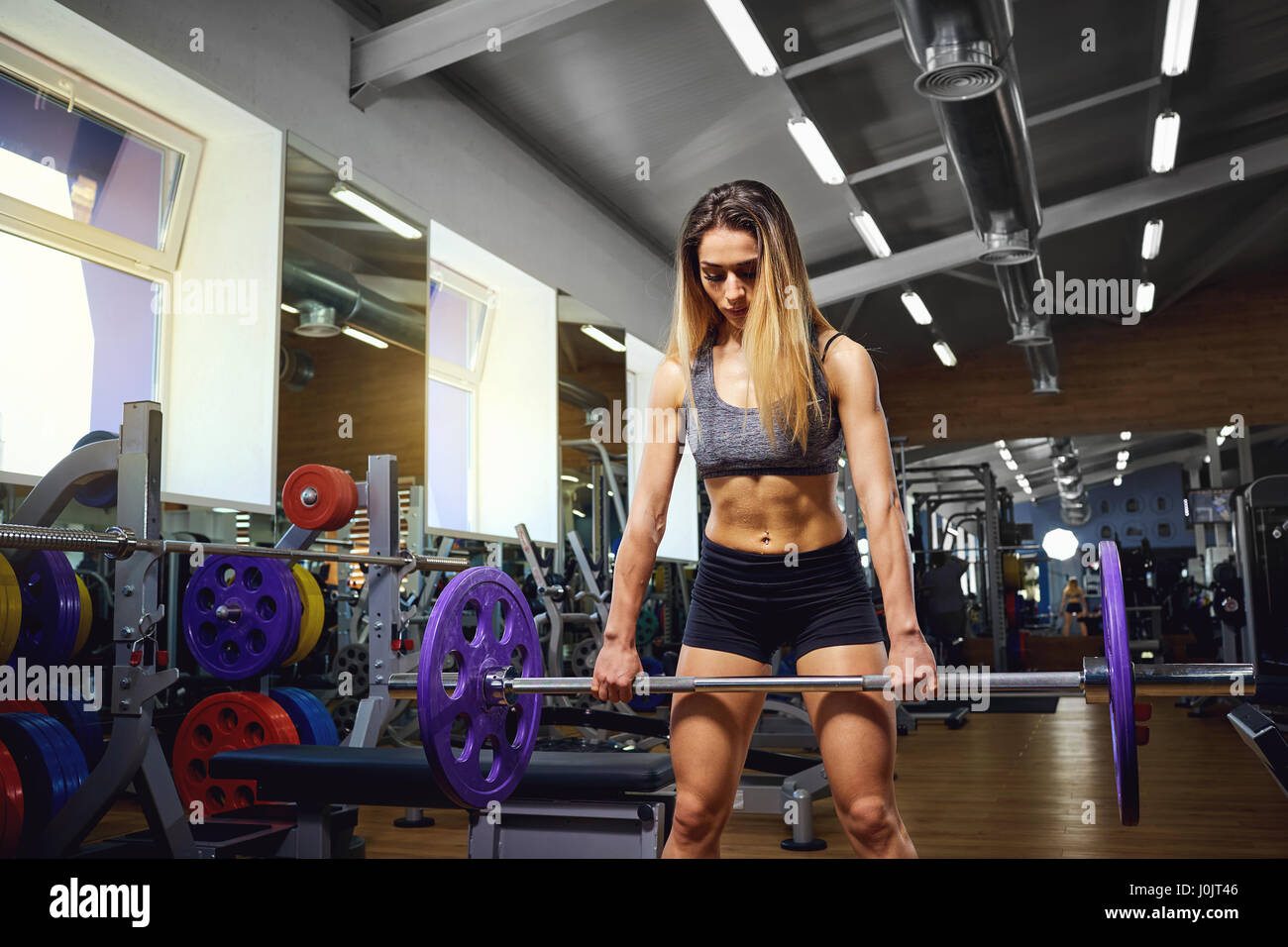 Girl with a barbell in the gym.  Stock Photo