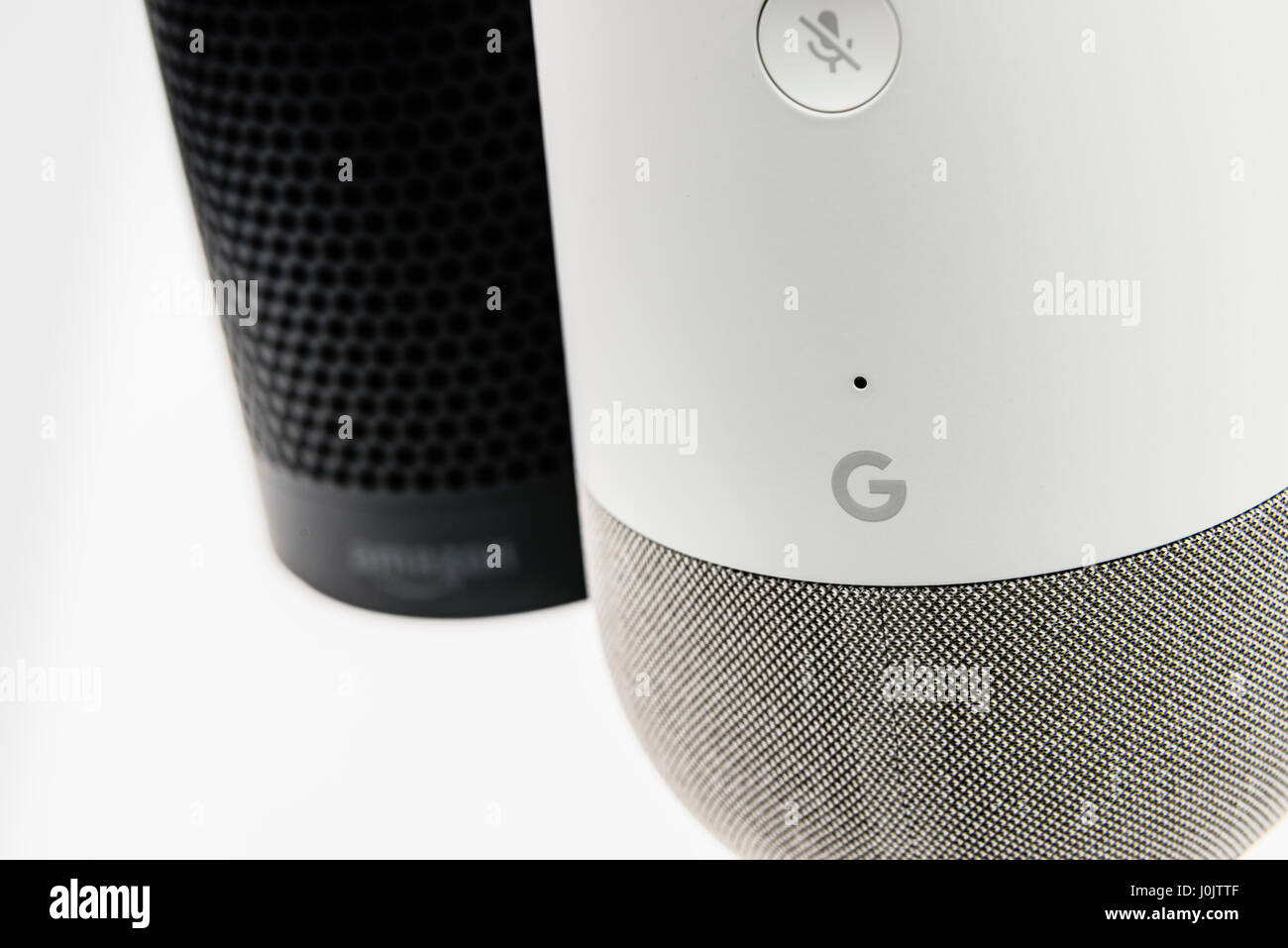 Google Home and Amazon Echo smart speakers.  Both offer voice activated personal assistants, music playing and home automation control. Stock Photo