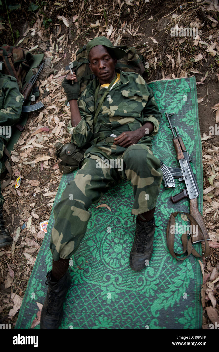 DRC national army (FARDC) soldier smokes a cigarette during operations against the Rwandan-backed rebel group M23 Stock Photo