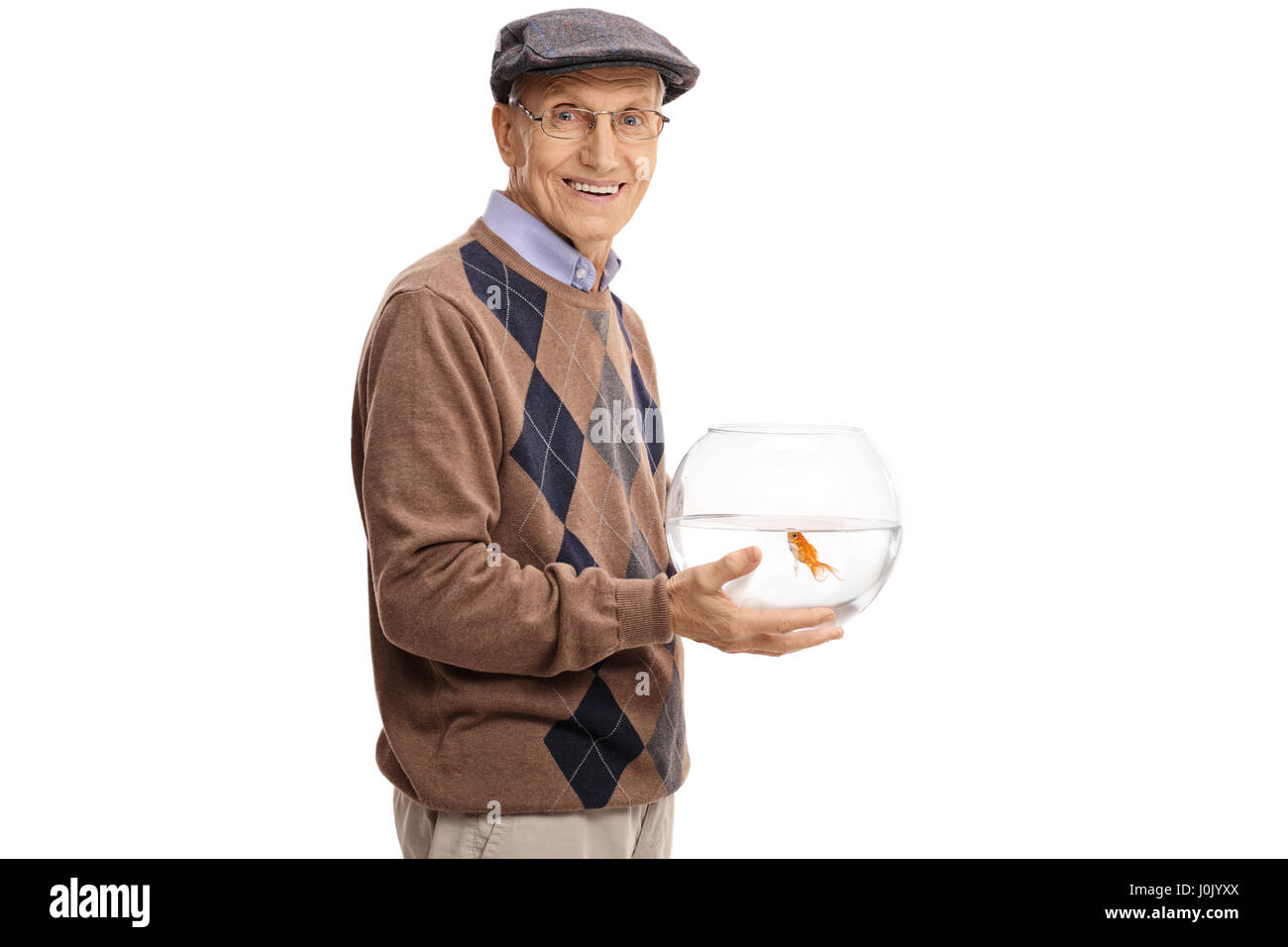 Elderly man holding a bowl with a goldfish and looking at the camera isolated on white background Stock Photo