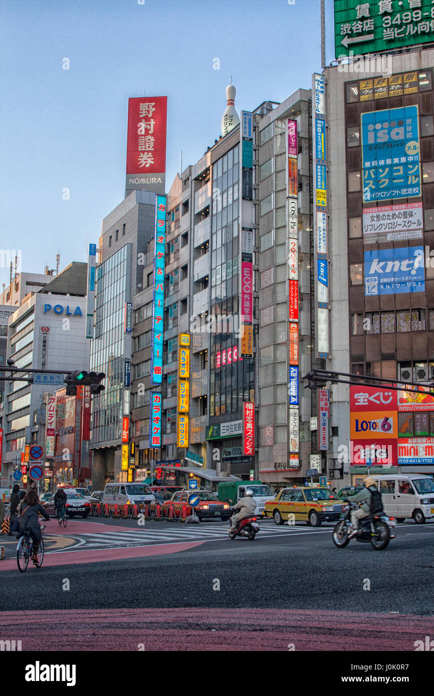 Cars and buildings in downtown Tokyo with billboards on the buildings Stock Photo