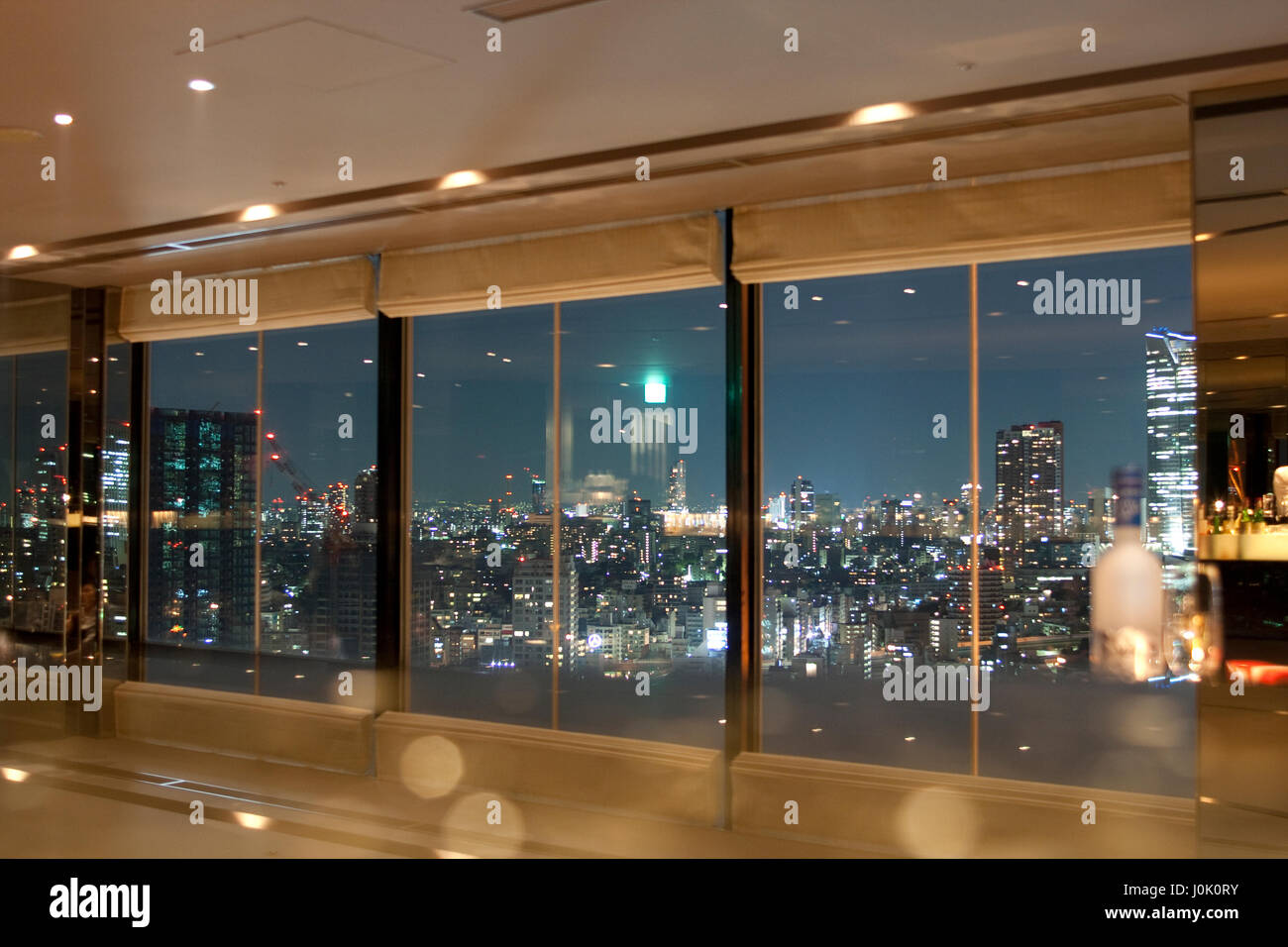 JAPAN, TOKYO , APRIL 4 2009:View on Tokyo and skytower by night through windows with some reflection of the interior Stock Photo