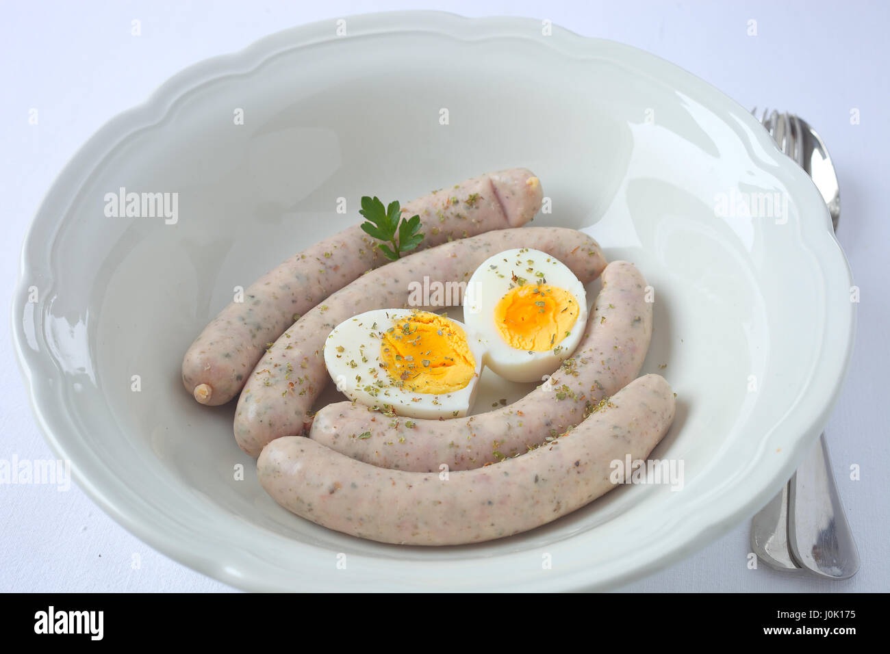 White sausage and egg in a soup bowl. Stock Photo