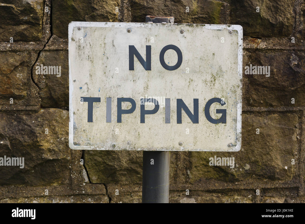 A dilapidated No Tipping sign warning against the illegal dumping of rubbish and garbage dumping Stock Photo