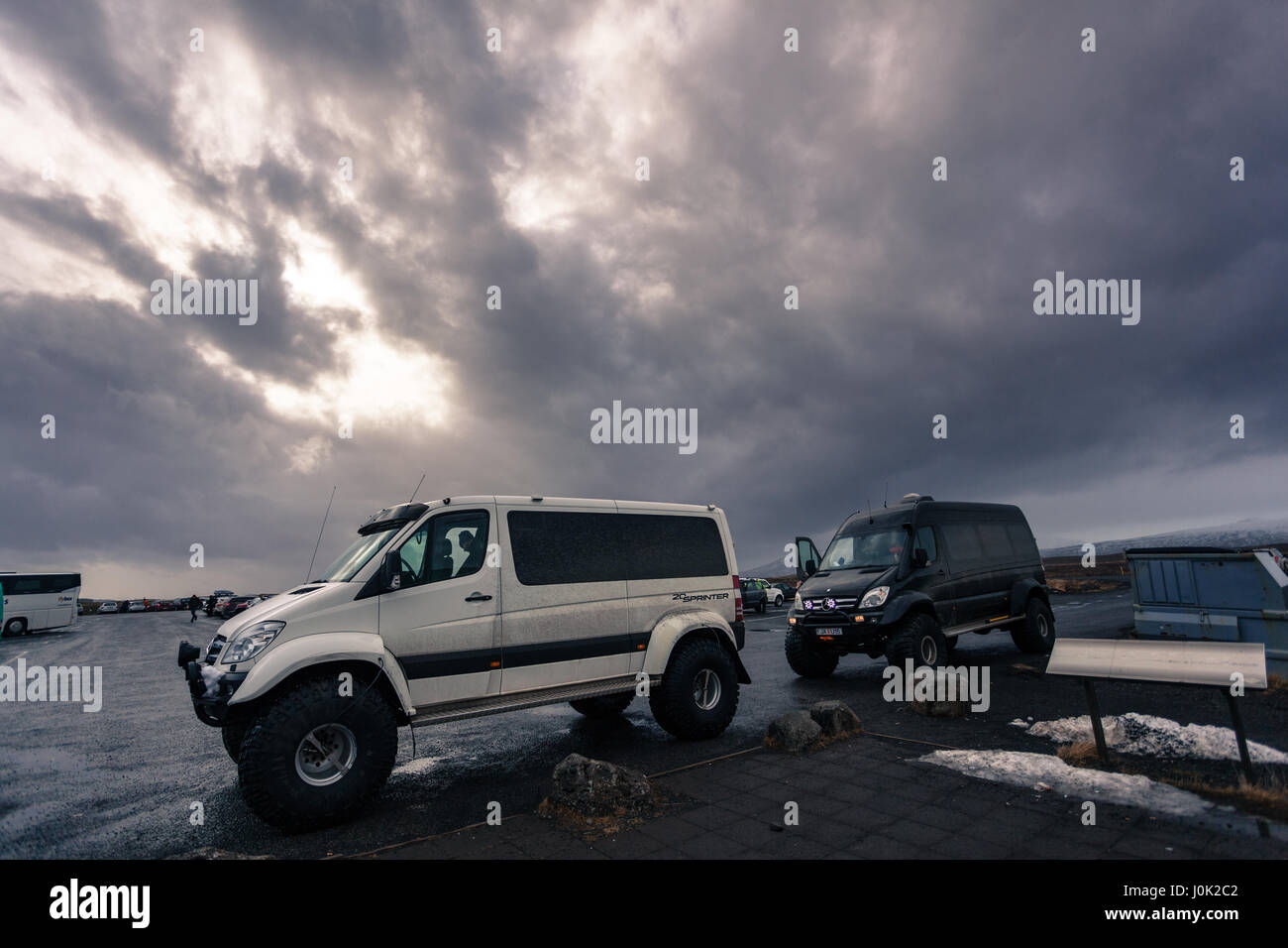 Off-road jeeps parked up beneath a leaden sky just outside Reykjavik, western Iceland Stock Photo