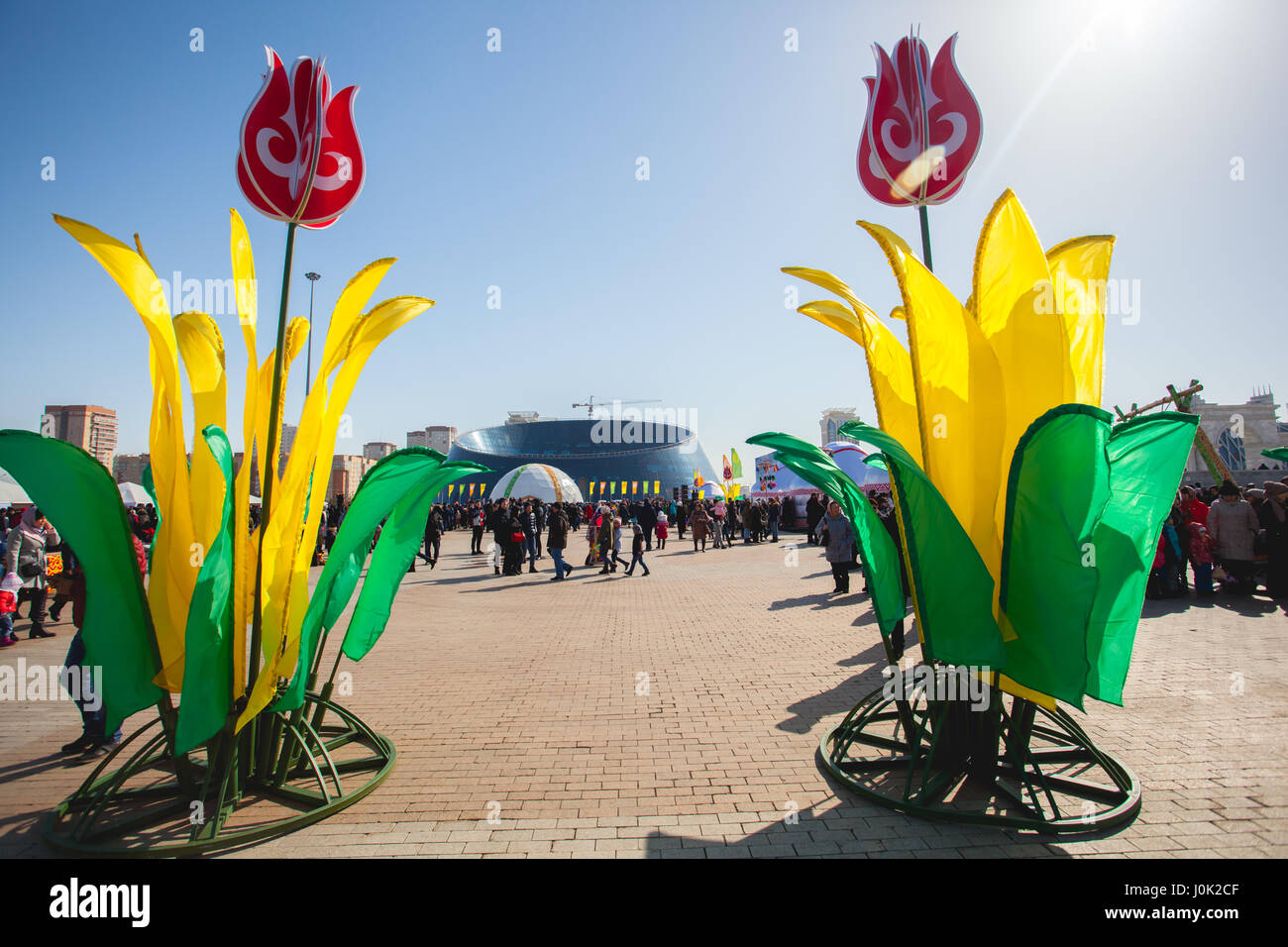 The traditional holiday of Nauryz in Astana on March 22. People are walking on a sunny day. There are concerts and different competitions. Stock Photo