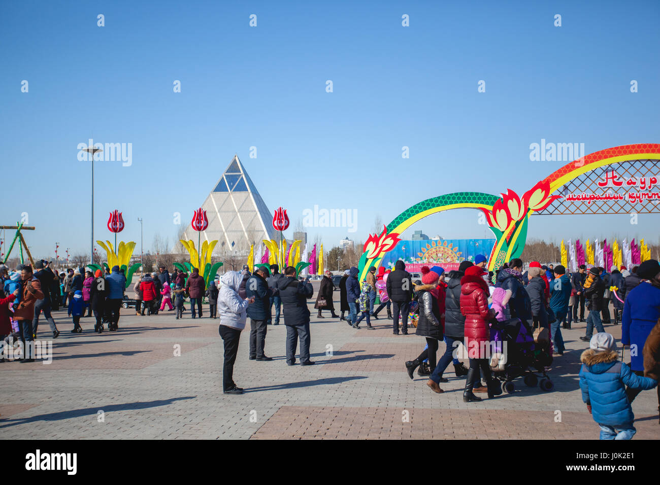 The traditional holiday of Nauryz in Astana on March 22. People are walking on a sunny day. There are concerts and different competitions. Stock Photo