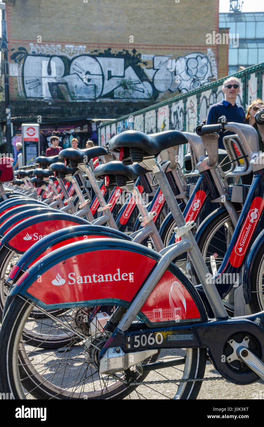 Santander hire bikes at a docking station on Brick Lane in East London. Stock Photo