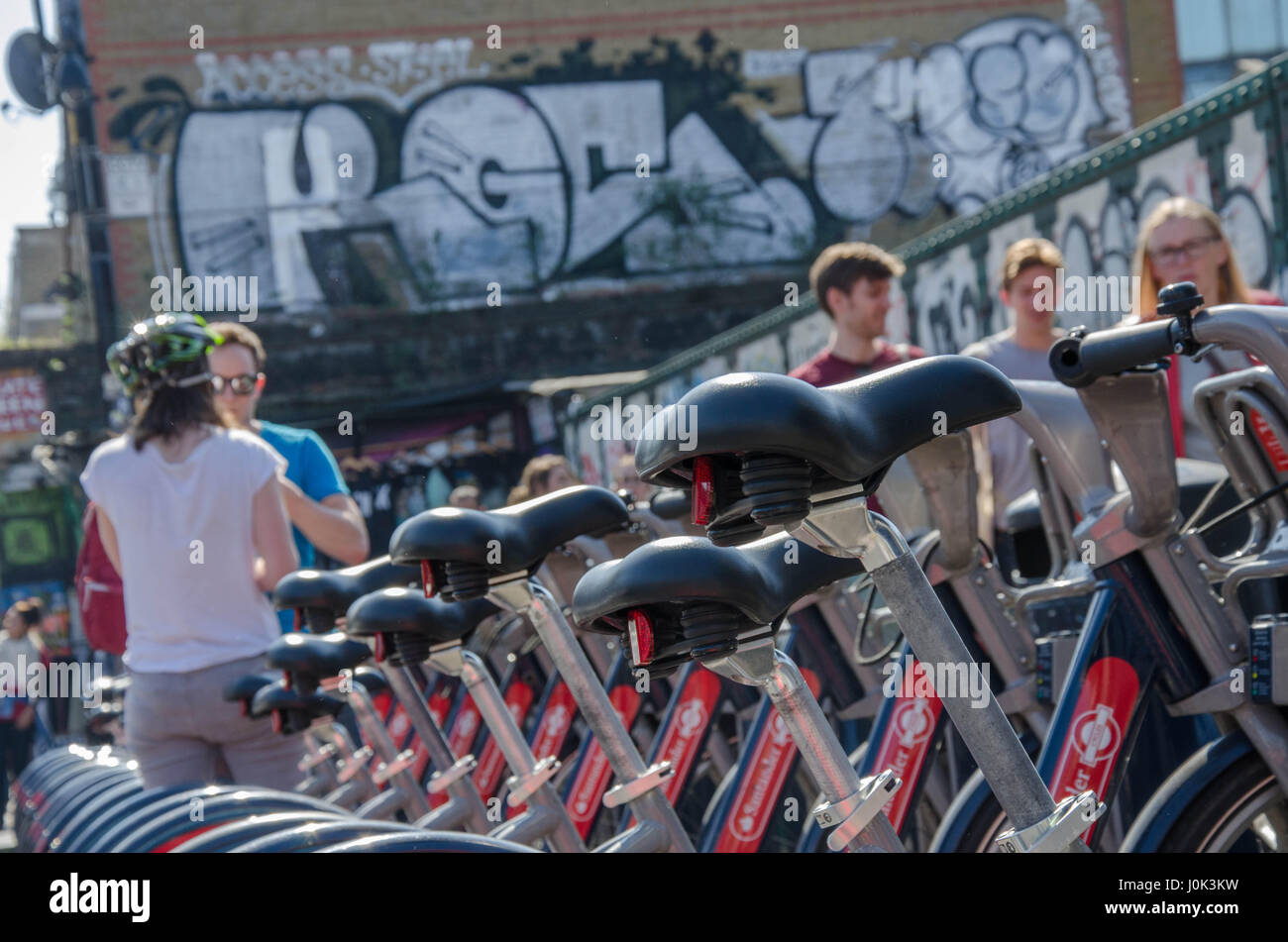 Santander hire bikes at a docking station on Brick Lane in East London. Stock Photo