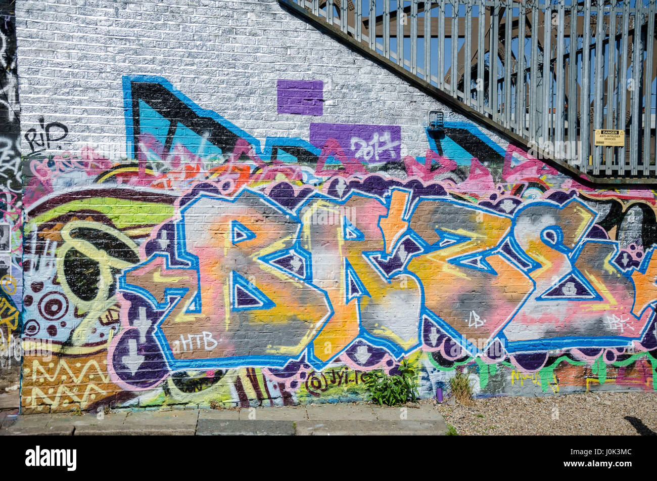 Colourful street art and graffiti on a wall in East London Stock Photo