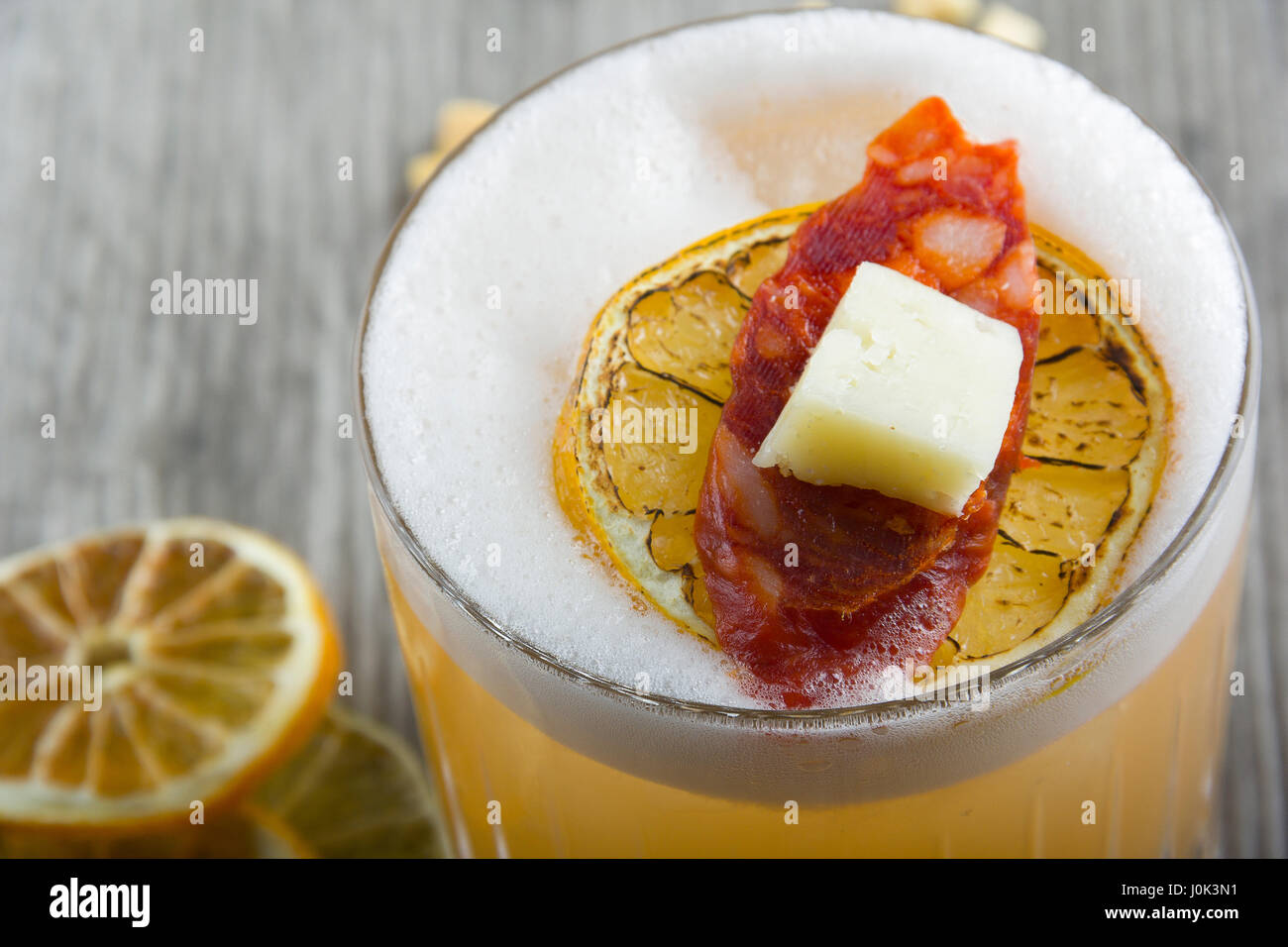 Single malt whiskey shaken with truffle infused honey water, lemon and egg white Stock Photo