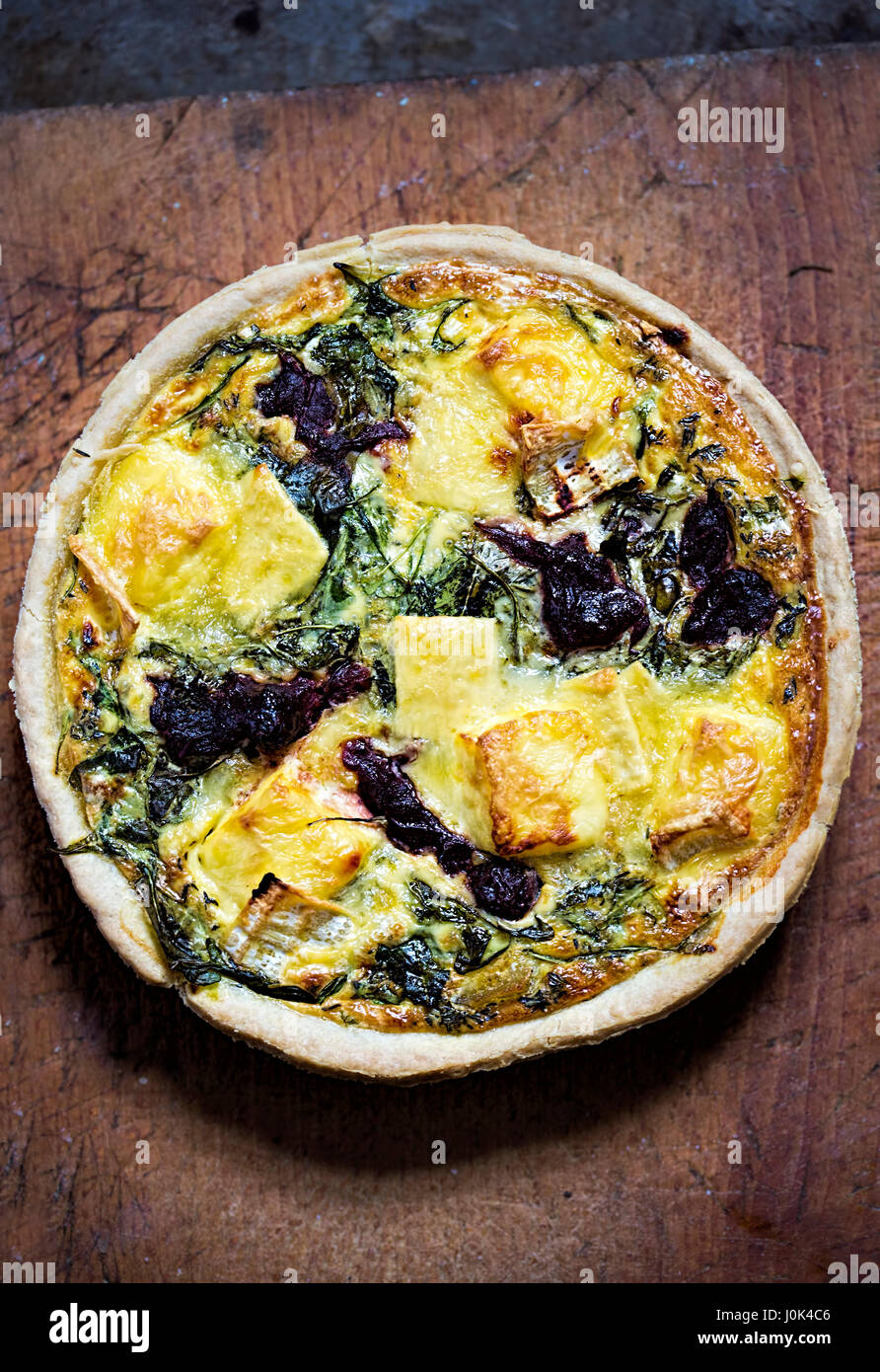 Festive brie, rocket leaves and cranberries quiche Stock Photo Alamy
