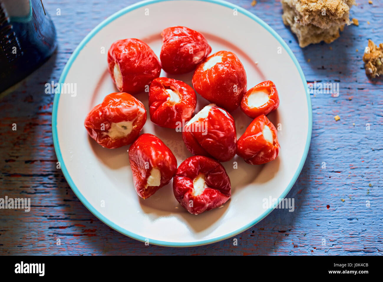 Peppers stuffed with feta cheese on white plate Stock Photo