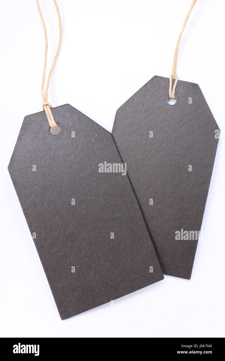 A photograph of two black paper price tags with string, for prices