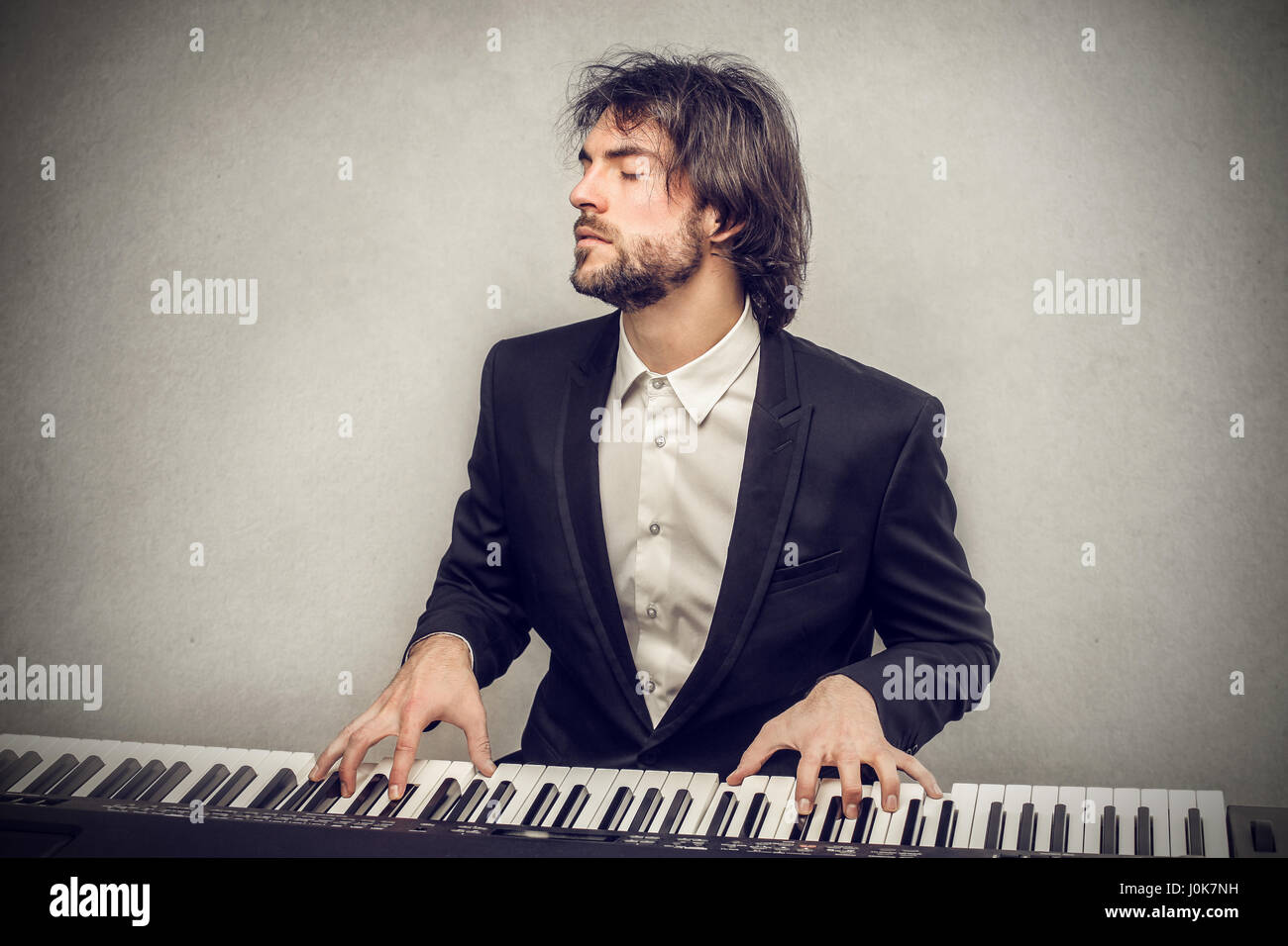 Man playing on piano Stock Photo Alamy
