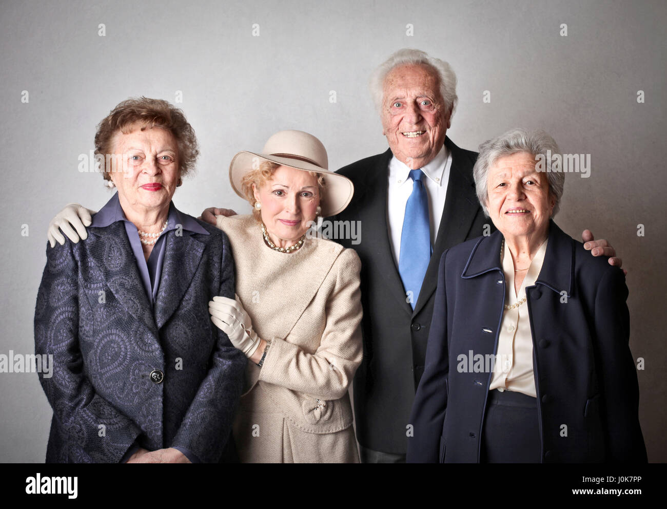 4 elegant old people posing for picture Stock Photo
