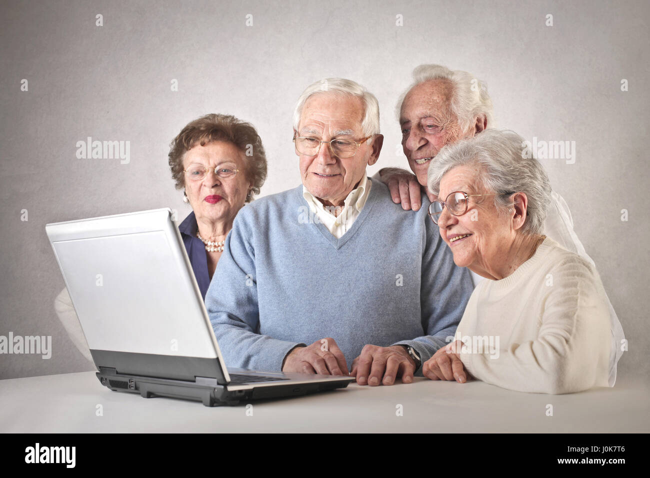 4 old people using laptop Stock Photo - Alamy