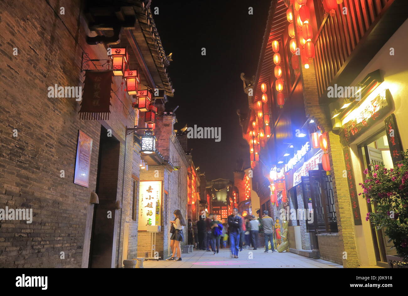 People visit East West street in Guilin China. East West street features boutiques, galleries, traditional teahouses, bars and cafes in folk styles. Stock Photo