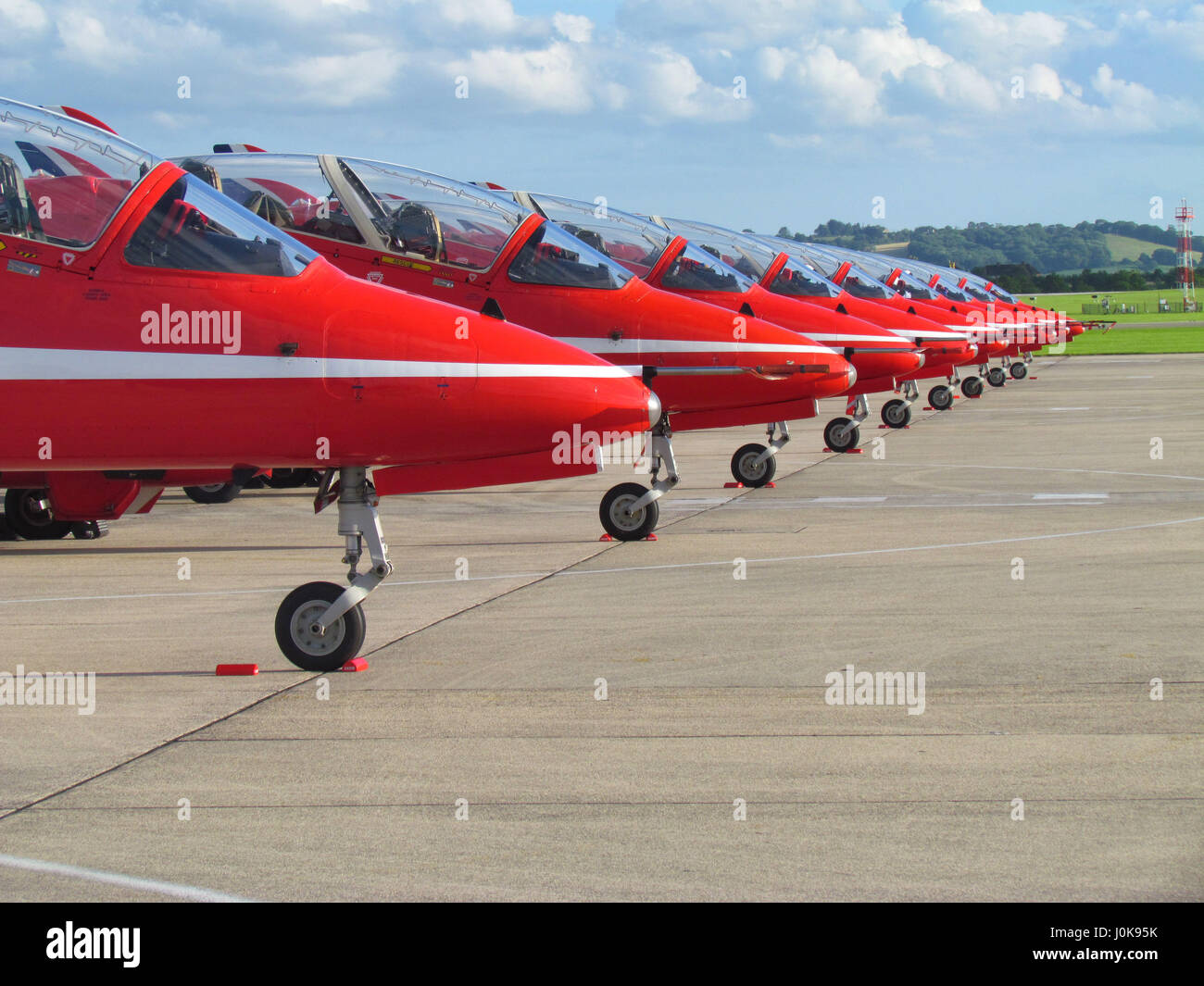 The Red Arrows parked in a line at RNAS Yeovilton, June 2012 with Somerset countryside in the background. Stock Photo